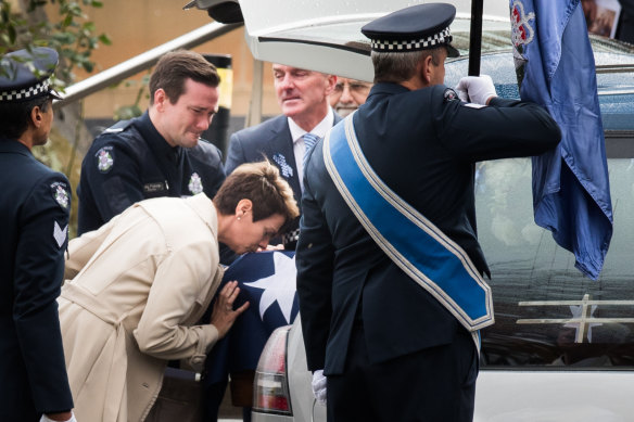 Constable Josh Prestney's mother Belinda kisses the casket, with son Alex and husband Andrew. 