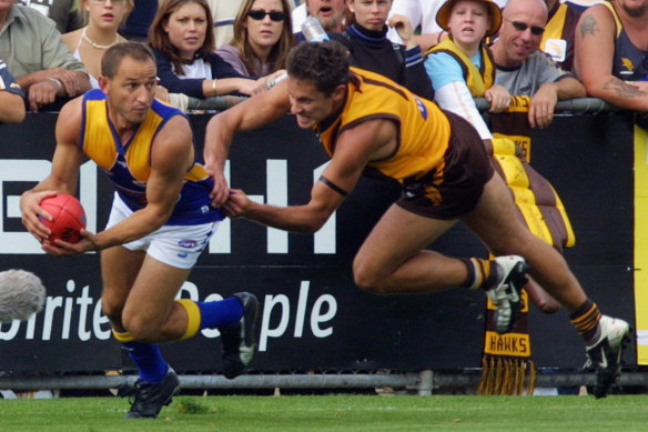 New football director at Hawthorn Luke McCabe tries to stop Eagles forward Phil Matera