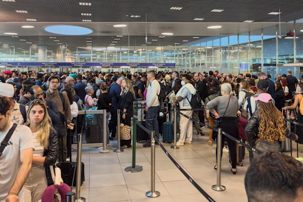 Queues of passengers at Lisbon Humberto Delgado Airport Arrivals waiting for immigration border control processing for up to 3 hours in June 2025