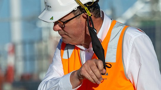 Premier Daniel Andrews takes off his mask on Tuesday.