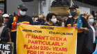 Invasion Day protesters in Melbourne with a sign critical of Prime Minister Scott Morrison’s comments that January 26, 1788 wasn’t a “flash day” for arriving convicts.