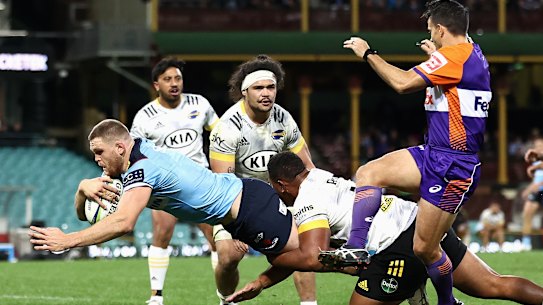 Lachlan Swinton of the Waratahs scores against the Hurricanes at the SCG.