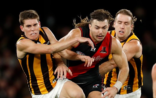 Aggression: Draper bursts through his Hawthorn opponents
