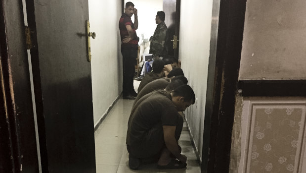 In this 2018 file photo, suspected Islamic State militants wait their turn for sentencing at the counterterrorism court in Baghdad, Iraq.