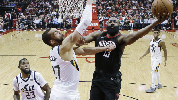 Houston Rockets guard James Harden drives to the basket past Utah Jazz centre Rudy Golbert.