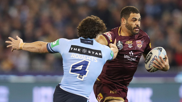 Greg Inglis attempting to discard James Roberts at the MCG.