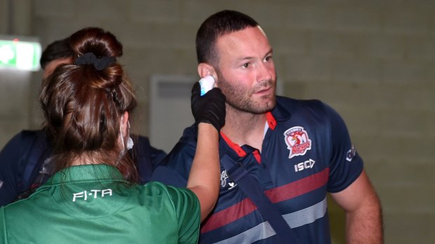 Roosters captain Boyd Cordner has his temperature taken before the clash with the Broncos. 