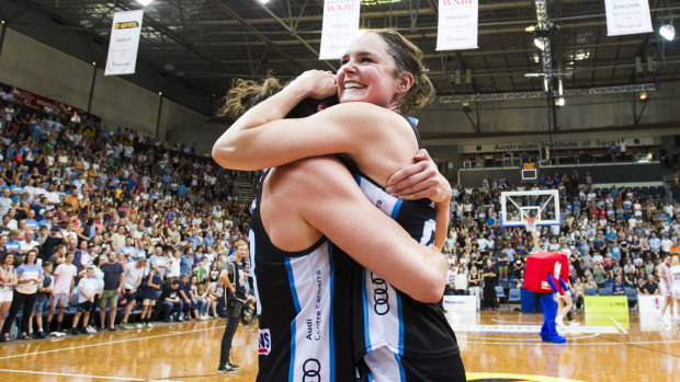Canberra Capitals celebrate after winning the grand final.