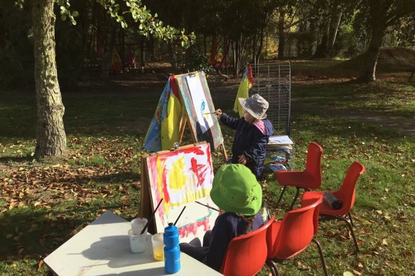 Children paint in the garden of the Khancoban Community Preschool.