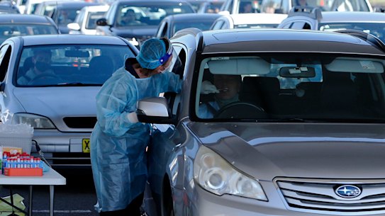 People queue for COVID-19 testing at Honeysuckle in Newcastle on Monday, after a nightclub party seeded 84 cases.