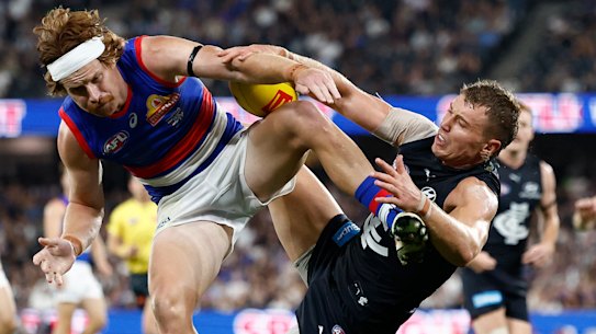 Patrick Cripps of the Blues and Oskar Baker of the Bulldogs in action.