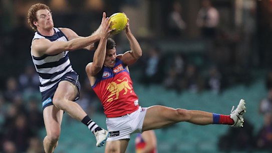 SYDNEY, AUSTRALIA - JULY 09: Brandon Starcevich of the Lions is challenged by Gary Rohan of the Cats during the round 6 AFL match between the Geelong Cats and the Brisbane Lions at Sydney Cricket Ground on July 09, 2020 in Sydney, Australia. (Photo by Matt King/AFL Photos/via Getty Images)