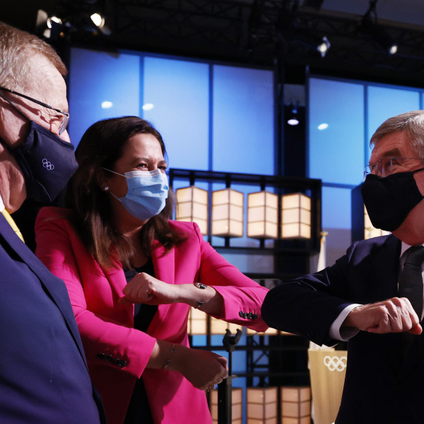 The president of the International Olympic Committee, Thomas Bach, right, bumps elbows with Premier Annastacia Palaszczuk and John Coates. 