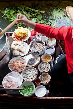 Damnoen Saduk Floating Market, Thailand - April 3, 2011: Food vendor at Damnoen Saduk Floating Market preparing Thai style noodles on a traditional boat. Many fresh ingredients are used and the overall combination of flavours is delicious. credit: istock
one time use for Traveller only