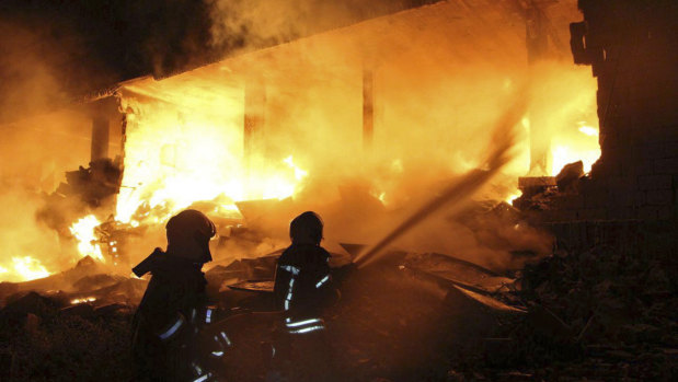 White Helmet rescuers extinguishing a fire at the scene of an explosion that hit a five-storey building in the village of Sarmada, near the Turkish border, north Syria, on Sunday.