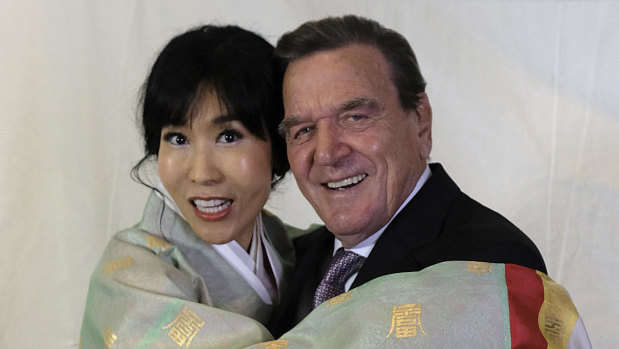 Former German Chancellor Gerhard Schroeder poses with his South Korean wife Kim So-yeon during a reception to celebrate their wedding in Berlin.