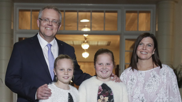 Prime Minister Scott Morrison with his wife Jenny and daughters Abigail and Lily pose for photos after being sworn-in at Government House in Canberra on Friday.