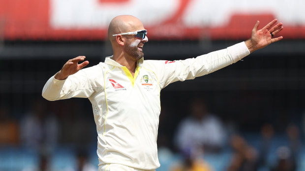 Nathan Lyon celebrates sending Rohit Sharma on his way.