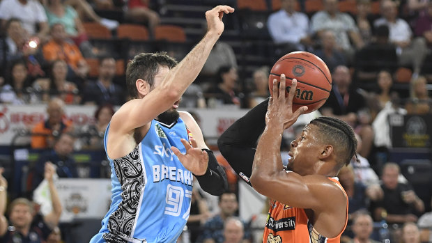 Scott Machado of the Taipans is fouled by Jarrad Weeks of the during the round 10 NBL match at the Cairns Convention Centre on Friday.