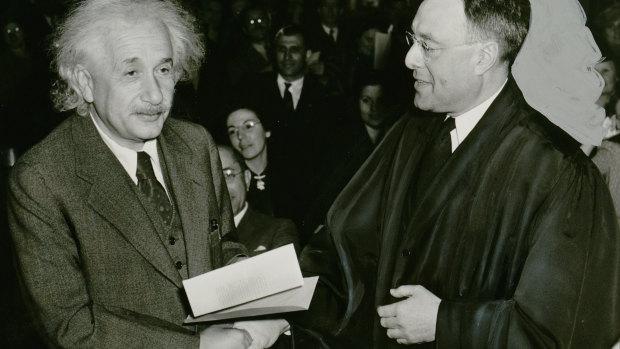 Albert Einstein receives  his certificate of American citizenship from Judge Phillip Forman in 1940.