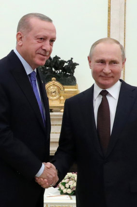 Russian President Vladimir Putin, right, and Turkish President Recep Tayyip Erdogan shake hands during their meeting at the Kremlin in Moscow, Russia.