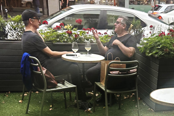 Guy Grossi (right) drinking wine at one of his Bourke Street restaurants on December 3.