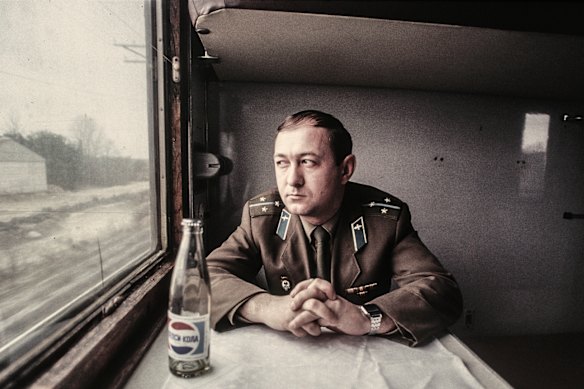A Soviet military officer looks out the window as he travels between Tallinn and Vilnius by train in 1989.
