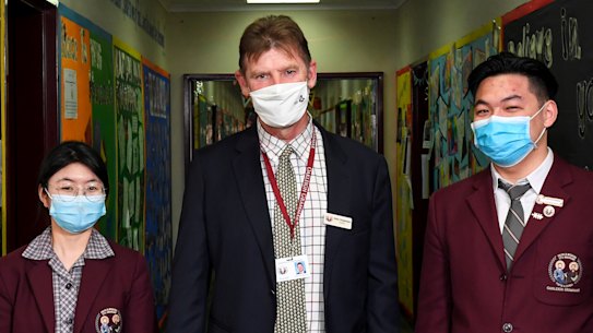 Oakleigh Grammar principal Mark Robertson with international students Betty from China and Sinky from Cambodia.