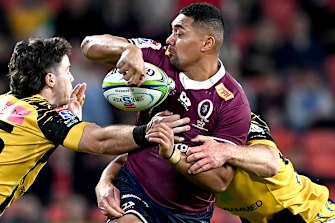 Chris Feauai-Sautia looks to slip a pass during the Reds' win at Suncorp Stadium on Friday night.