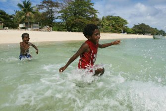 Kids play on Masig Island in the Torres Strait swims during hide tide. King tides and strong winds have caused flooding on several islands in the Torres Strait generating concerns over climate change and rising sea levels. 