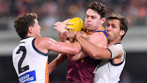 Not so fast: Matt de Boer (right) locks down on Lions star Lachie Neale.