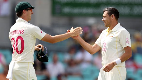 Pat Cummins congratulates silent assassin Scott Boland.