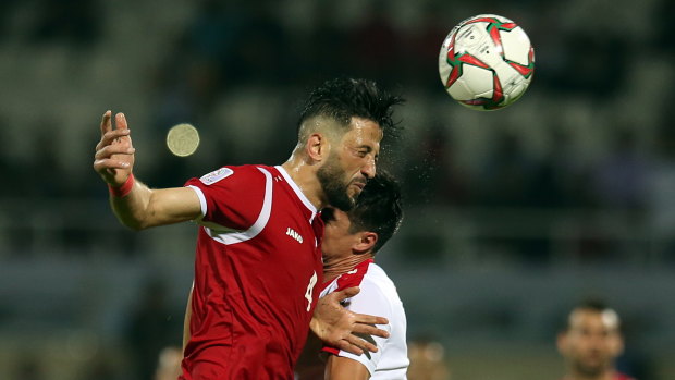Revenge on their minds: Syria's Jehad Al Baour heads the ball during their Asian Cup clash with Palestine.