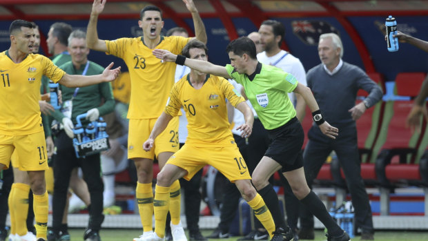 Spot fire: The Socceroos react after referee Andres Cunha consults VAR on the penalty.