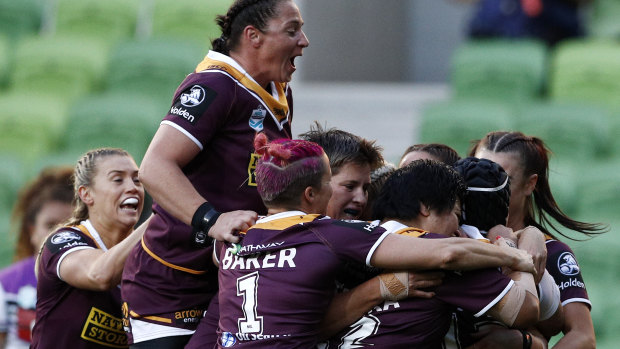 Minor premiers: The Broncos celebrate after Julia Robinson scores against the Warriors at AAMI Park.