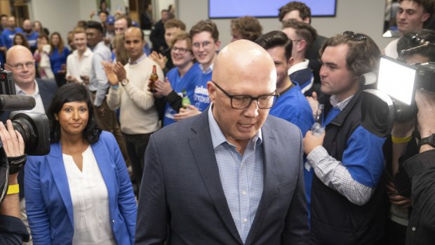 Young Liberal activist Barclay McGain (right) watches party leader Peter Dutton and Roshena Campbell arrive for concession speeches after losing the Aston byelection.