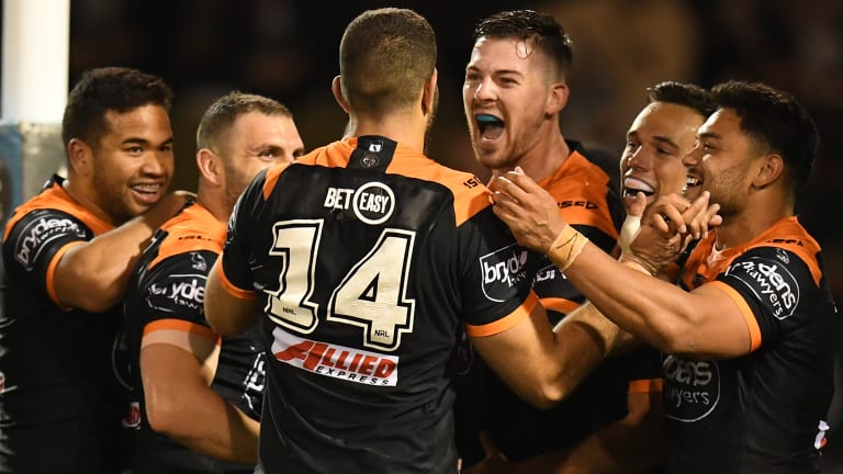 Don't count us out just yet: The Tigers celebrate a try on Thursday night.