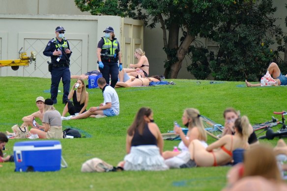 People enjoying the warm weather at St Kilda beach on Saturday.
