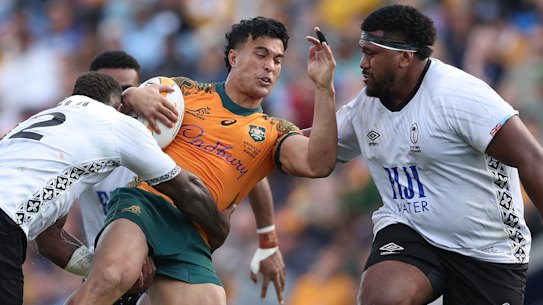 Joseph-Aukuso Suaalii of the Wallabies is tackled.