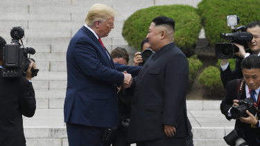 US President Donald Trump shakes hands with North Korean leader Kim Jong-un in the DMZ on Sunday.