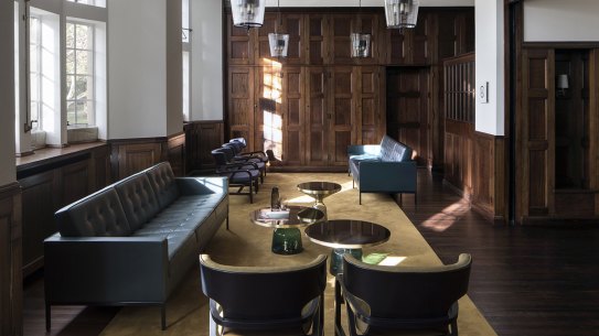 An interior suite at BMA House features many of its original features, including timber panelling.