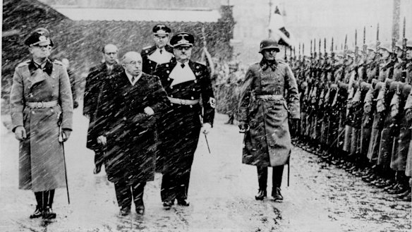 Czecholoslovakian President Emil Hacha inspecting a guard of honour in a snowstorm in Berlin after handing over his country to Hitler in 1939.