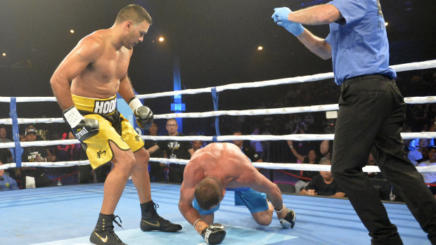 Justin Hodges (left) and Rob Baron in action during the Star of the Ring charity fight night at Hordern Pavilion on Friday.