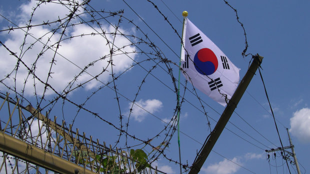 The South Korean flag seen through barbed wire at the DMZ, in Panmunjeom, South Korea.