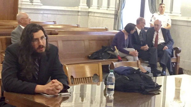 Michael Rotondo, left, in court during an eviction proceeding in Syracuse, New York, brought by his parents, Mark and Christina, of Camillus. The parents confer with their lawyer, Anthony Adorante, in the court gallery behind. 