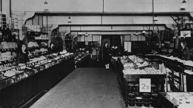 
A section of Woolworths' original "Bargain Basement" which opened in the Imperial Arcade, December 5, 1924. A sales docket and the customer's money were propelled by overhead wire to the cashier in her "eagle's nest" at top right. The receipt and change were then returned to the counter by the same method.
