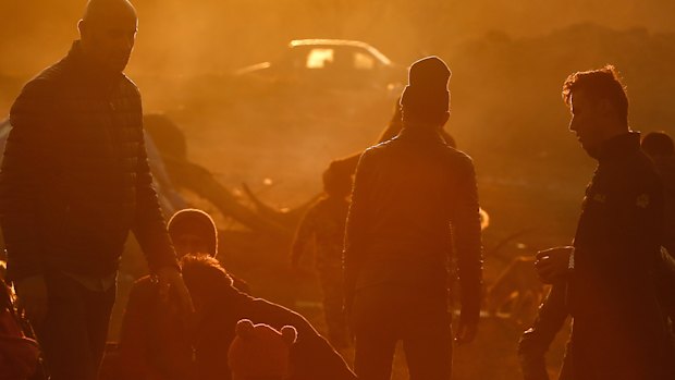 Migrants gather in a field near Edirne, at the Turkish-Greek border on Monday.