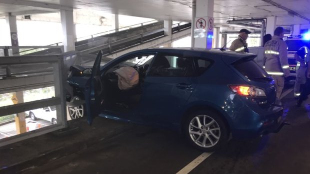 A woman is lucky to have avoided serious injury after crashing her car through a shopping centre car park barrier.