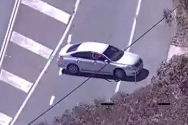 A PolAir helicopter tracking a stolen silver sedan was in the line of fire when a young man on the run is accused of firing a shot at the aircraft.