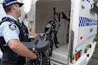 A South Sydney police officer seizes an e-bike during a recent operation.